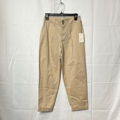 A. New Day Women’s Stretch Pants Color Tan Spring Khaki High-waisted Work Pants, Spring High-waisted Chinos, Tapered High Waist Pants For Spring, Spring Khaki Ankle-length Chinos, Casual High Waist Spring Chinos, Spring Tapered Beige Pants, Beige Work Pants With Pockets For Spring, Spring Beige Work Pants With Pockets, Spring Beige Tapered Leg Chinos