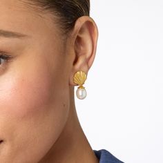 Each earring features a detailed golden scallop shell with an oval pearl dangling beneath. Sanibel Shells, Julie Vos, Scallop Shell, Scallop Shells, Gold Plated Earrings, Pearl Drop Earrings, Pearl Drop, Pierced Ears, Earring Backs