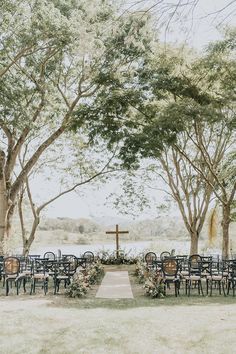 an outdoor ceremony setup with chairs and tables