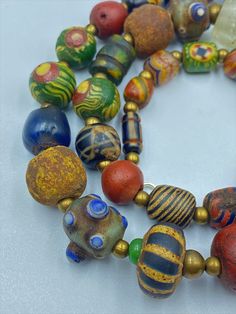 The Beautiful Ancient Glass Beads Necklace From Ancient Historic Cultures Civilizations Artisan Single Strand Bracelets With Round Beads, Artisan Single Strand Bracelet With Round Beads, Artisan Glass Beads, Traditional Multicolor Single Strand Beads, Ancient Style Gemstone Beads Jewelry For Gift, Artisan Single Strand Multicolor Beads, Artisan Multicolor Single Strand Beads, Collectible Ancient Style Pendant Necklace, Ancient Handmade Ceremonial Jewelry