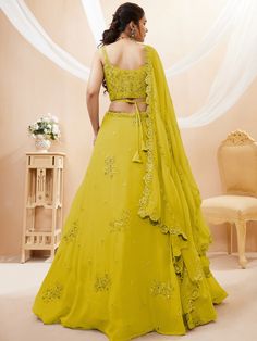 Introducing our adorable neon yellow sequins georgette wedding wear lehenga choli, a vibrant and stylish outfit that is perfect for any special occasion. This exquisite piece is made from high-quality georgette material in a stunning neon yellow color. It features intricate dori work, glitter sequin work, and embroidery work, adding a touch of elegance and glamour to the ensemble.
The set includes a matching georgette choli that is adorned with the same dori work, glitter sequin work, and embroi Yellow Georgette Party Dress, Yellow Georgette Dress With Dori Work, Pista Green Chinon Lehenga For Party, Yellow Embellished Lehenga For Navratri, Party Lehenga In Pista Green Chinon, Party Wear Wedding Lehenga In Georgette, Festive Yellow Embellished Lehenga, Party Pista Green Chinon Lehenga, Wedding Party Wear Lehenga In Georgette