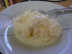 a white plate topped with ice cream and a spoon