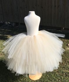 "This listing includes an ivory and champagne/beige tutu with a gold glitter bow. This listing if for waist sizes up to 34 1/2\" can be made larger if interested contact me for a special listing. Other colors also available. The ivory and champagne/beige tutu pictured is the 19-24\" length range with a longest layer of 20\" and top layer of 17\". Tutu can be all one length or the dual lengths. **please just note the length you would like or lengths you would like upon checkout Thank you for shop Cream Embroidered Tulle Fabric, Tulle Tutu Dress For Cake Smash, Elegant Fitted Cream Tutu Dress, Cream Tulle Tutu Dress For Wedding, Fitted Princess Style Cream Tutu Dress, Fitted Gold Tulle Tutu Dress, Fitted Cream Tulle Skirt, Fitted Cream Tutu Dress With Tulle Skirt, Fitted Cream Tulle Fabric For Party