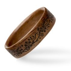 a wooden ring with floral designs on it