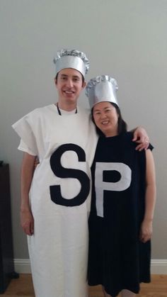 two people dressed in costumes standing next to each other, one wearing a s p shirt