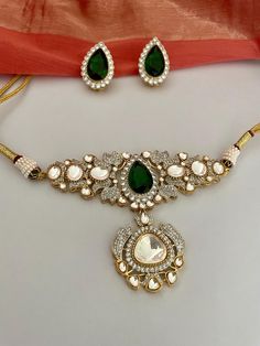 High quality emerald green kundan jewelry set that stands out for being unique and beautiful!  Radiate splendour in this kundan choker set embellished with CZ and green carved stones, delicately handcrafted for you. Details: Necklace Width-2.75 Inches Earrings Length-2.25 Inches Weight of Each Earring-14 gms All products are manufactured using traditional skills from our rich heritage of crafts.  The process of these crafts is essentially manual. Hence, any irregularities or variations are an inherent part of these handcrafting processes. Emerald Kundan Necklace For Gift, Kundan Necklace Hand Set As Gift, Festival Gift Kundan Necklace With Rose Cut Diamonds, Festive Gift Kundan Necklace With Rose Cut Diamonds, Festivals Gift Kundan Necklace With Rose Cut Diamonds, Diamond Kundan Necklace Gift, Luxury Stone Work Jewelry Sets For Festive Occasion, Kundan Jewelry With Rose Cut Diamonds For Gift, Kundan Necklace With Rose Cut Diamonds For Celebration