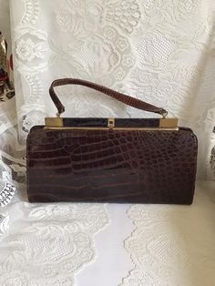 Vintage 1960's large size handbag. It is either Reptile embossed leather OR possibly genuine Alligator. I can feel possible scales, but cannot say for sure if it is real Alligator or not. No makers label or marks inside the bag. This is a nice large size bag. Has one large inside main compartment with a small inside slip and zippered pocket. Has a great SNAP sound when clasp is closed. Because I don't know if this is genuine Alligator or not, I cannot ship the bag international. *CONDITION & MEA Alligator Handbags, Top Handle Bags, Vintage Purses, Vintage Purse, Looks Style, Vintage Handbags, Vintage Frames, Vintage Bags, Embossed Leather