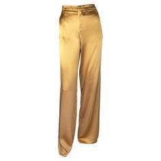 Presenting a luxurious pair of golden silk-blend pants designed by Tom Ford for Gucci's Spring/Summer 2001 collection. The silk and viscose blend and wide-leg construction give these pants a shimmering appearance that beautifully captures light and movement, day or night. Unfinished hems allow you to create the perfect fit on this rare piece of Gucci history! Approximate measurements: IT40 32" waist 38" hips 37" inseam 47" total length 25" diameter pant cuffs 84% silk 16% viscose Gucci Stretch Bottoms For Women, Luxury Fitted Gucci Bottoms, Luxury Elegant Gucci Bottoms, Chic Gucci Luxury Pants, Gucci Luxury Formal Pants, Gucci Formal Pants For Women, Elegant Gucci Luxury Pants, Classic Luxury Gucci Bottoms, Gucci Fitted Designer Pants