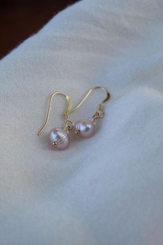 Handmade with 14k gold filled materials, a swarovski crystal and a champagne/peach fresh water pearl. Pearls are associated with commitment, feminine energy and inner wisdom. 14k Rose Gold Pearl Earrings Gift, Elegant Pink Gold Jewelry With Ear Wire, Delicate Hypoallergenic Rose Gold Pearl Earrings, Elegant Hypoallergenic Pink Gold Earrings, Rose Gold Pearl Earrings With Ear Wire For Anniversary, Champagne Color Drop Earrings For Gift, Rose Gold 14k Gold-filled Pearl Drop Earrings, Rose Gold Pearl Drop Earrings In 14k Gold Filled, Rose Gold Pearl Drop Earrings 14k Gold Filled