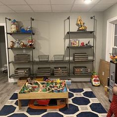 a child's play room with toys and shelves