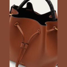 Chloe "Marcie" bucket bag in grained leather  Rolled top handle Detachable, adjustable crossbody strap, 19.6" drop Can be worn as a top handle or crossbody bag  Drawstring closure  Lining: Leather Approx. 6.7"H x 7.1"W x 3.9"D Item Weight (Lbs.): 1.1 Professional cleaning recommended Made in Italy Leather Roll, Chloe Marcie, Professional Cleaning, 7 H, Crossbody Strap, Drawstring Bag, Top Handle, Bucket Bag, Chloe