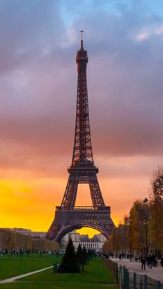 the eiffel tower is lit up at sunset