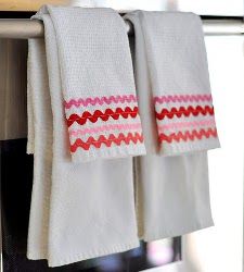 two white towels hanging on a towel rack