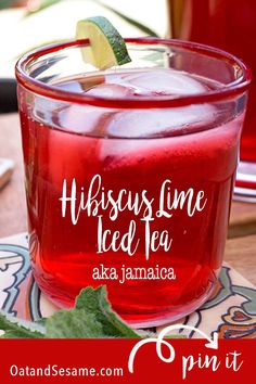 a red drink sitting on top of a wooden table