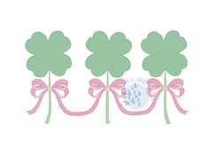 three green shamrocks with pink bows and a blue egg in the center on a white background