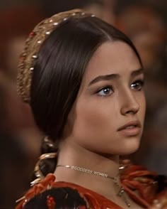 a young woman wearing an ornate head piece