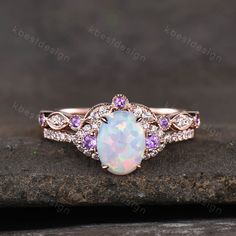 This is a beautiful lab created white fire Opal engagement ring in rose gold. Main Stone: 6x8mm oval cut opal. Side stone: Amethyst + Moissanite. Wedding band: Curved band, Moissanite.. This ring is marked G10K/G14K. I accept custom making order.Please contact me if you need this service. For all the jewelries,there is a 14 days money back guarantee.You can return it in the time frame without any questions.However there maybe handcrafted fee and shipping fee deducted from the original payment as Ruby Engagement Ring Set, White Opal Engagement Ring, Opal Engagement Ring Rose Gold, Fire Opal Engagement Ring, Opal Engagement Ring Set, Oval Cut Ring, Opal Engagement Ring, Cute Engagement Rings, Opal Wedding Rings