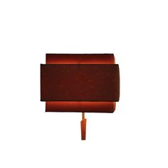 a lamp that is sitting on top of a wooden pole with a red shade over it