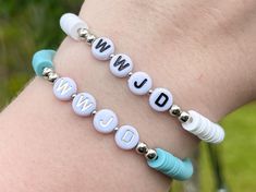 Available as a single bracelet (WWJD - silver or black letters - with heishi beads) or as a set (WWJD - silver or black letters - with heishi beads + silver bead bracelet) with 2 separate bracelets. Cross charms are also available to add on to both the single bracelet and the set! Need a different size? Message me! As this product is handmade, string and glue may be visible up close CAUTION: Choking Hazard Silver Beaded Bracelets With Letter Beads, Nickel Free White Beaded Bracelets For Friendship, Nickel-free White Beaded Bracelets For Friendship, Trendy Silver Stretch Bracelet With Letter Beads, Personalized Silver Beaded Bracelets Casual Style, Personalized Silver Beaded Bracelets, Casual Silver Stretch Bracelet With Letter Beads, Casual Silver Bracelets With Letter Beads, Silver Name Bracelet With Letter Beads For Friendship