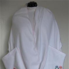 a white robe with embroidered flowers on it