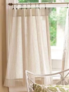 a white chair sitting in front of a window