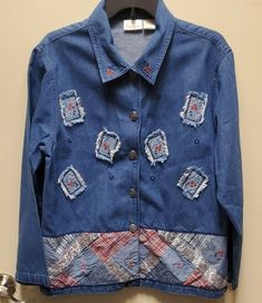 Condition Used Bobbie Brooks  Jacket Shirt   Embossed and Patch Work  Women'sSize Large12/14 Rn 31762 Made in Bangladesh Sizing Approx: 18"  Shoulder to Shoulder 24"  Shoulder to End of Jacket Shirt 34"  Shoulder to Middle of Collar to End of Sleeve 32"  Chest 44"  Waist 44"  Hip 23"  Front From Collar to End of Jacket  Shirt 28" Back From Collar to End of Jacket Shirt Color May Vary By Camera of Light Pictures is What You get Pattern: Embroidered Floral Sleeve Length: Long Sleeve Neckline: Butt Casual Long Sleeve Denim Top With Floral Embroidery, Fall Patchwork Denim Top, Casual Patchwork Denim Top For Fall, Fall Denim Blue Patchwork Denim Top, Denim Blue Patchwork Top For Fall, Long Sleeve Denim Top With Floral Embroidery, Fall Denim Blue Patchwork Top, Embroidered Blue Button-up Denim Jacket, Blue Embroidered Button-up Denim Jacket