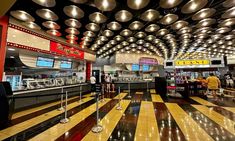 the inside of a food court with lights hanging from the ceiling