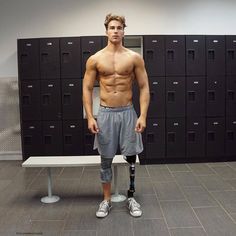 a shirtless man standing in front of lockers with his hands on his hips