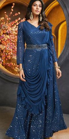 "Festive Blue Georgette Party Wear Gown - Style 1813539"Celebrate in style with the Festive Blue Georgette Party Wear Gown. Crafted from luxurious georgette fabric, this gown combines elegance with a contemporary twist, making it perfect for any festive occasion or party. The rich blue color adds a vibrant yet sophisticated touch, ensuring you stand out at weddings, galas, or special celebrations.#FestiveGown#BlueGeorgetteDress#PartyWear Sequence Dress Long Gowns, Gown With Attached Dupatta, Western Party Wear Dresses, Party Wear Long Gowns, Western Party Wear, One Piece Gown, Gown Indian, Navy Blue Gown, Long Gown Design