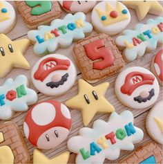 decorated cookies are arranged on a table for a mario themed birthday party, with the number five spelled out