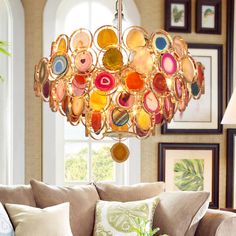 a living room filled with furniture and a chandelier hanging over the top of it