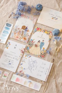 the wedding stationery is laid out on the table