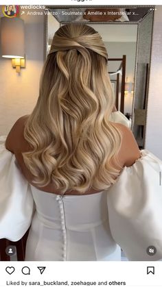 the back of a woman's head with long blonde hair styled into a half - updo