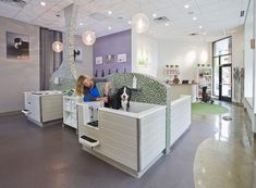 two women sitting on couches in an office setting with purple walls and flooring