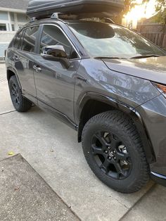 a gray suv parked in front of a house