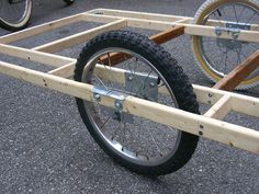 a bicycle is attached to a wooden cart