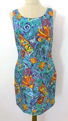 Vintage 90's tropical floral print silk dress. This dress reminds me of the rich colors of Key West. Gorgeous teal, green, dark blue, orange, yellow, and purple splashy floral print on 100% silk. Sleeveless sheath style, with a fitted waist and hidden back zip. Completely lined with white fabric. A comfortable dress that can be worn for all occasions! Fits like a modern size medium but please double-check the measurements below to ensure the best fit for you. --- M E A S U R E M E N T S --- Bust: up to 36" Waist: up to 31"  Hips: up to 40" Length: 35" Fabric: Dress: 100% Silk, Lining: 100% Acetate Label/Era: Tracy M / 1990 Stated Size: M Condition: Excellent condition. No issues.  ★ Shop entire shop here: https://www.etsy.com/shop/retrosuzysvintage Instagram | retrosuzysvintage Pinterest | Print Silk Dress, Silk Sheath Dress, Tropical Floral Print, Abstract Floral Print, Floral Abstract, Silk Print Dress, Dress Medium, Green Dark, Tropical Floral