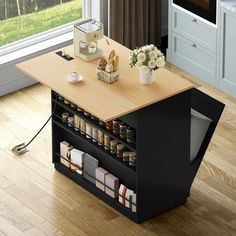 a kitchen island with spices on it in front of a window