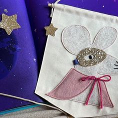 an embroidered book with a mouse on it