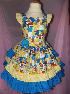 a yellow and blue dress with cartoon characters on it