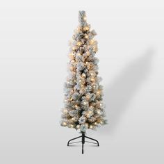 a white christmas tree with lights on it