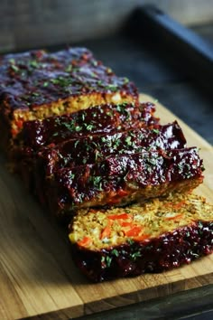 slices of meatloaf sitting on top of a wooden cutting board