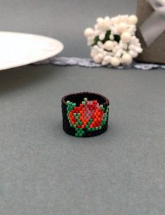 Black Beaded Rings For Gift, Black Flower Shaped Rings For Gift, Black Flower-shaped Rings For Gifts, Red Beaded Rings As Gift, Red Beaded Rings For Gifts, Red Beaded Rings Perfect As Gifts, Black Rings With Round Beads As Gifts, Beaded Flower Ring With Round Beads As A Gift, Beaded Flower Ring Gift