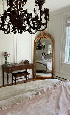 a bedroom with a bed, dresser and mirror in it's centerpieces