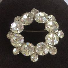 "Featuring this lovely and sparkly clear rhinestone circle brooch. It has a silver tone setting and measures 2\" diameter. The brooch is in very good vintage condition." Anniversary Rhinestone Round Brooches, Anniversary Brooches With Rhinestones, Anniversary Round Rhinestones Brooches, Anniversary Round Brooches With Rhinestones, Round Rhinestone Brooches For Formal Occasions, Round Formal Brooches With Rhinestones, Formal Round Brooches With Rhinestones, Formal Round Rhinestone Brooches, Crystal Round Brooch For Party