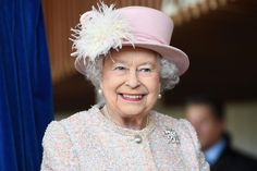 an older woman wearing a pink hat and coat