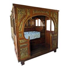 an ornate wooden bed frame with carved wood carvings on the sides and doors open to reveal a sleeping area