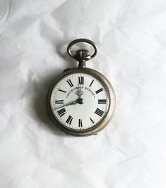 Victorian 'Gre Roskopf Patent' Pinset Pocket watch  *Not in Working Order. Has a beautiful floral engraving on the back.  Swiss Made.  Condition: Not in working condition, time can be set but the winding does not seem to work. It is possible that this can be professionally fixed if the purchaser wishes to do so. Pocket watch shows multiple signs of wear and aging. Spots are seen on the inside mechanical area.   **All the items that I sell are vintage and as a result some of them are perfectly imperfect :-) Please let me know if you have any questions! **Returns: There are no returns on items, all items are sold as is** Measurements: Height with clasp: 7 cm L & W: 5 cm **Sizing is subjective some people like things worn loose and some like it tight. Please let me know if you have any questi Pocket Watch Aesthetic, Pocket Watch Design, Floral Engraving, Old Pocket Watches, Antique Objects, Stop Watch, Watch Ideas, 80's Music, Vintage Clocks