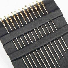 the comb is made from black material with gold pins on each side and two rows of needles