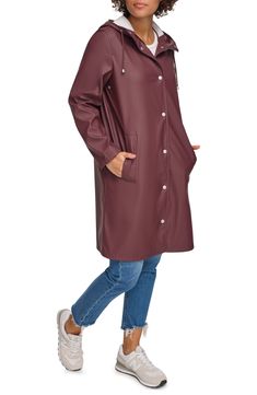 Durable and versatile, this hooded rain jacket features a drawstring hood, covered zipper placket and welt pockets to keep your hands warm and dry. 38 1/2" length Drawstring hood Water-resistant 100% polyurethane Machine wash, tumble dry Imported Trendy Hooded Raincoat For Outdoor, Trendy Hooded Outerwear For Rainy Weather, Trendy Fall Outdoor Raincoat, Waterproof Long Sleeve Hooded Jacket For Fall, Casual Hooded Raincoat With Adjustable Hood, Fall Outerwear With Drawstring Hood For Rainy Weather, Casual Raincoat With Drawstring Hood, Trendy Winter Raincoat For Rainy Weather, Fall Long Sleeve Raincoat With Double-lined Hood